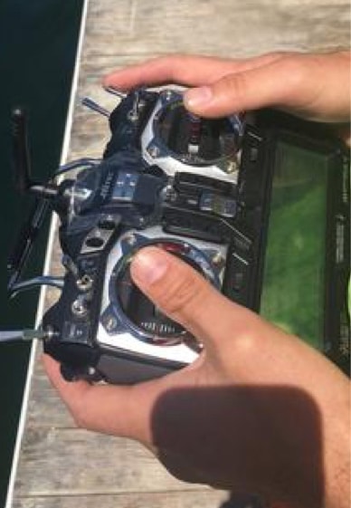 hands holding a remote controller for the Z-boat