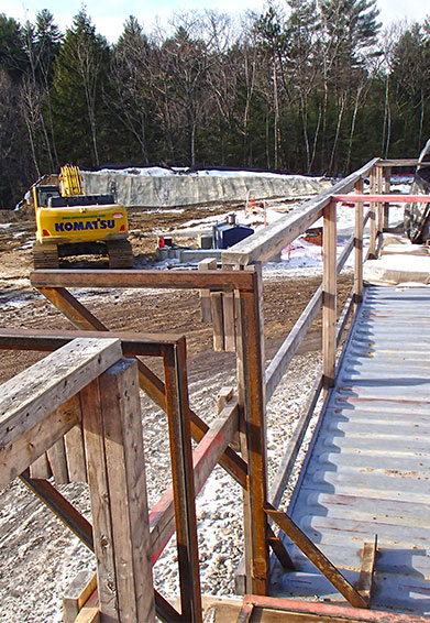 construction site in the winter with an excavator in the background