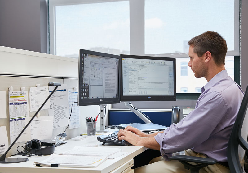 man working at desk on a computer