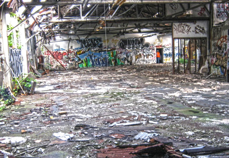 run down site with graffiti covered walls and litter covering the floor at Project Test 4 1